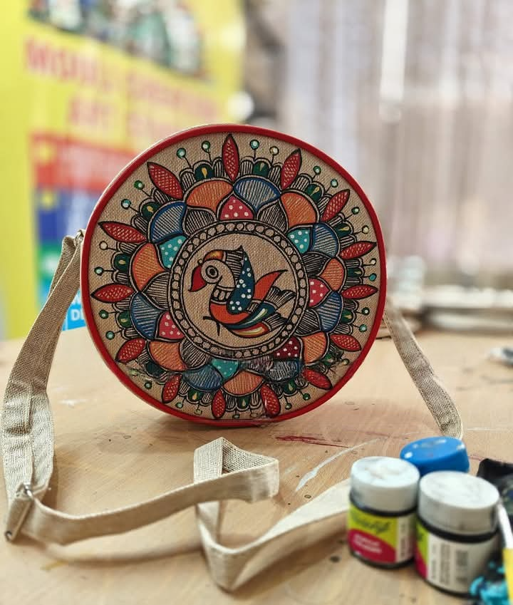 Round hand-painted sling bag with floral bird artwork